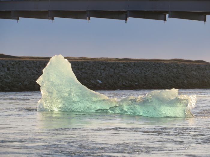Iceberg floating out to sea under Ring Road bridge (Jökulsárlón)