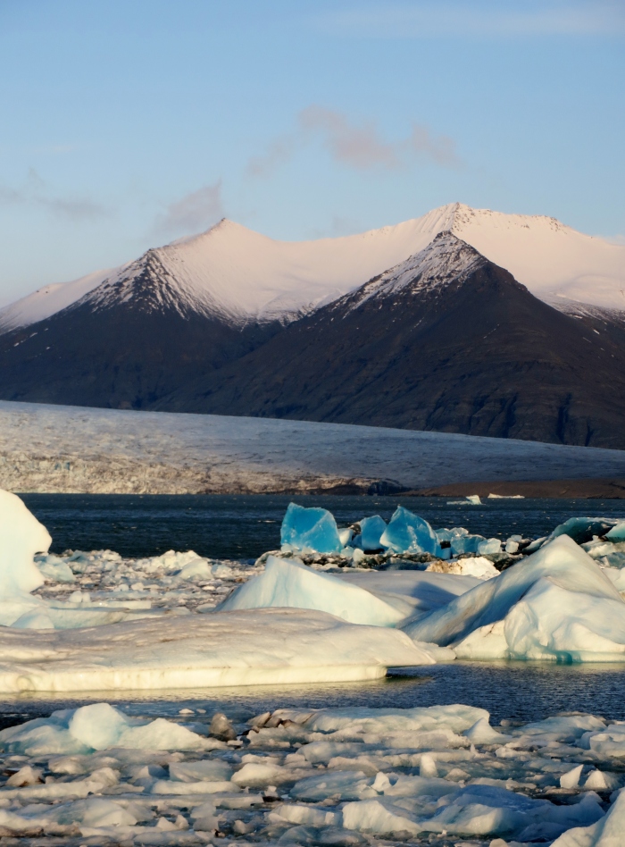 Amazing blue icebergs in the lagoon at Jökulsárlón. Breiðamerkurjökull glacier in the background